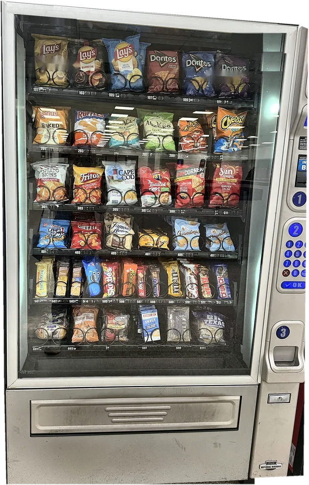 Snack machine with six rows of chips, cookies, candy bars and pastries, accepting cards.